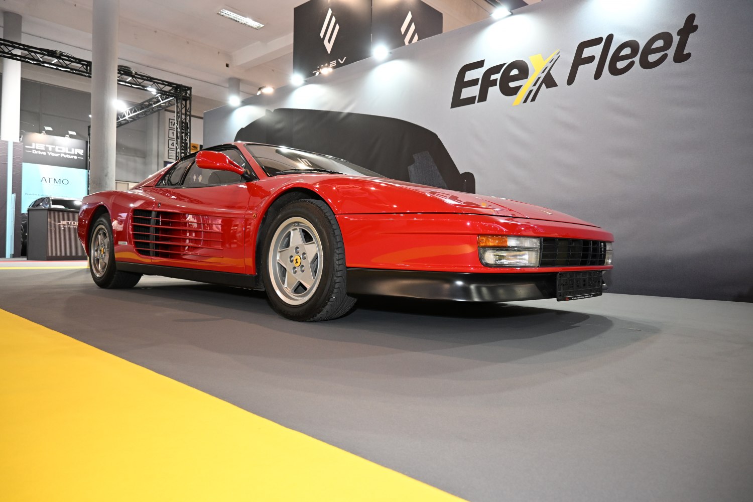 Red sports car with distinctive side strakes and sleek front design