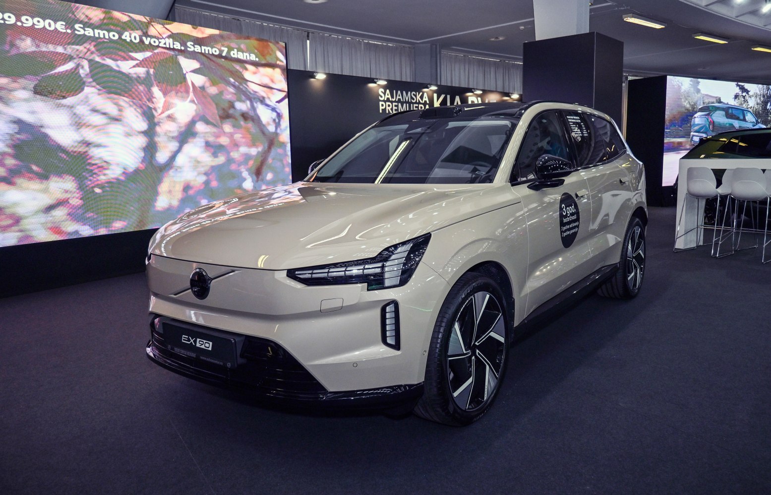 Front three-quarter view of a modern electric SUV with sharp LED headlights and distinctive wheels.