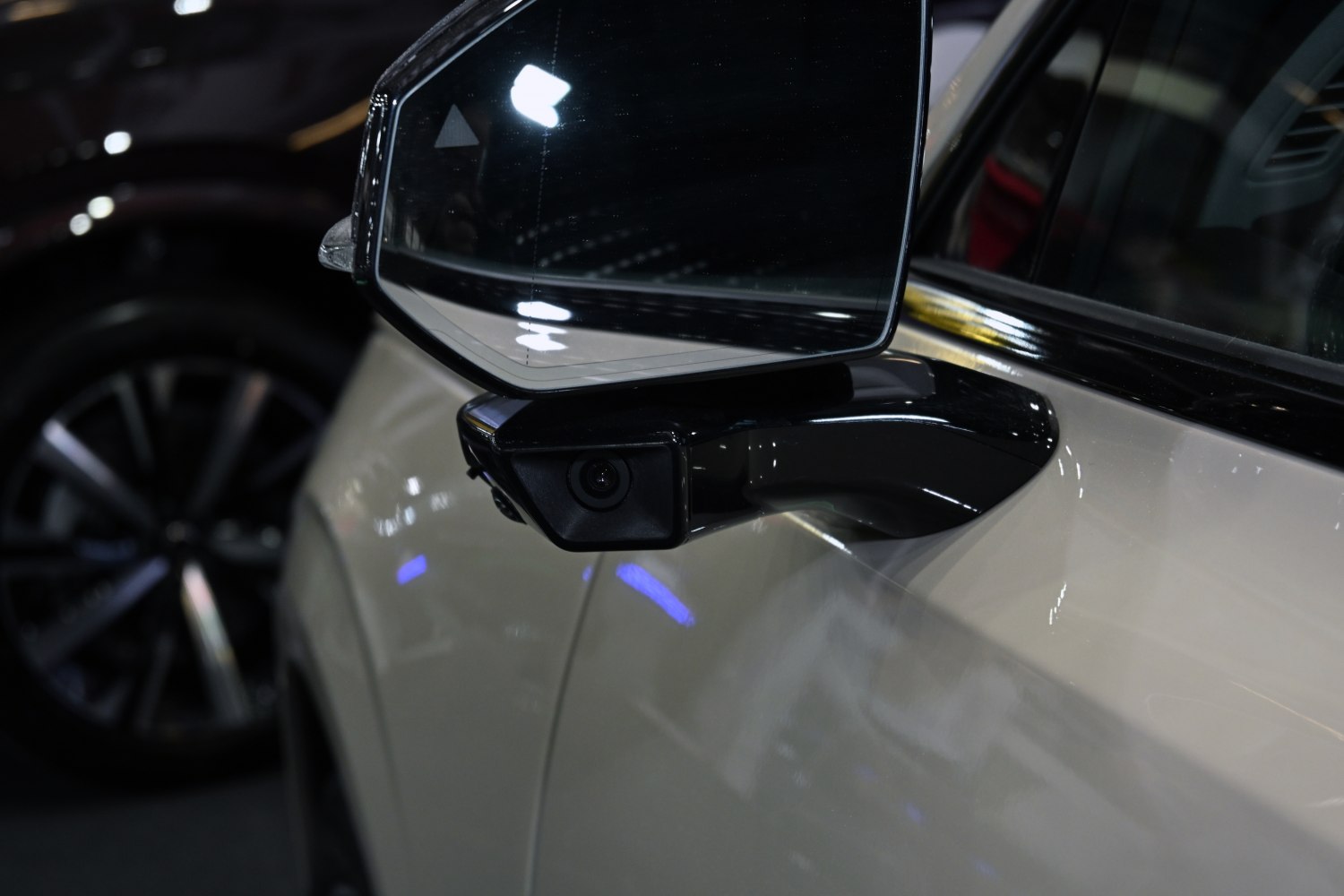 Close-up of side mirror with integrated camera on a modern SUV