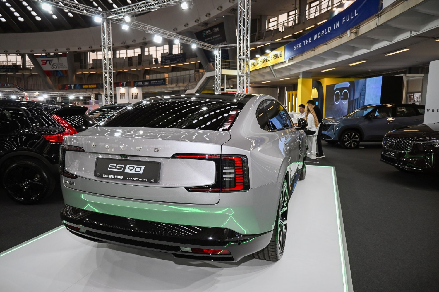 Rear view of electric sedan with sleek, modern taillights and dynamic lines.