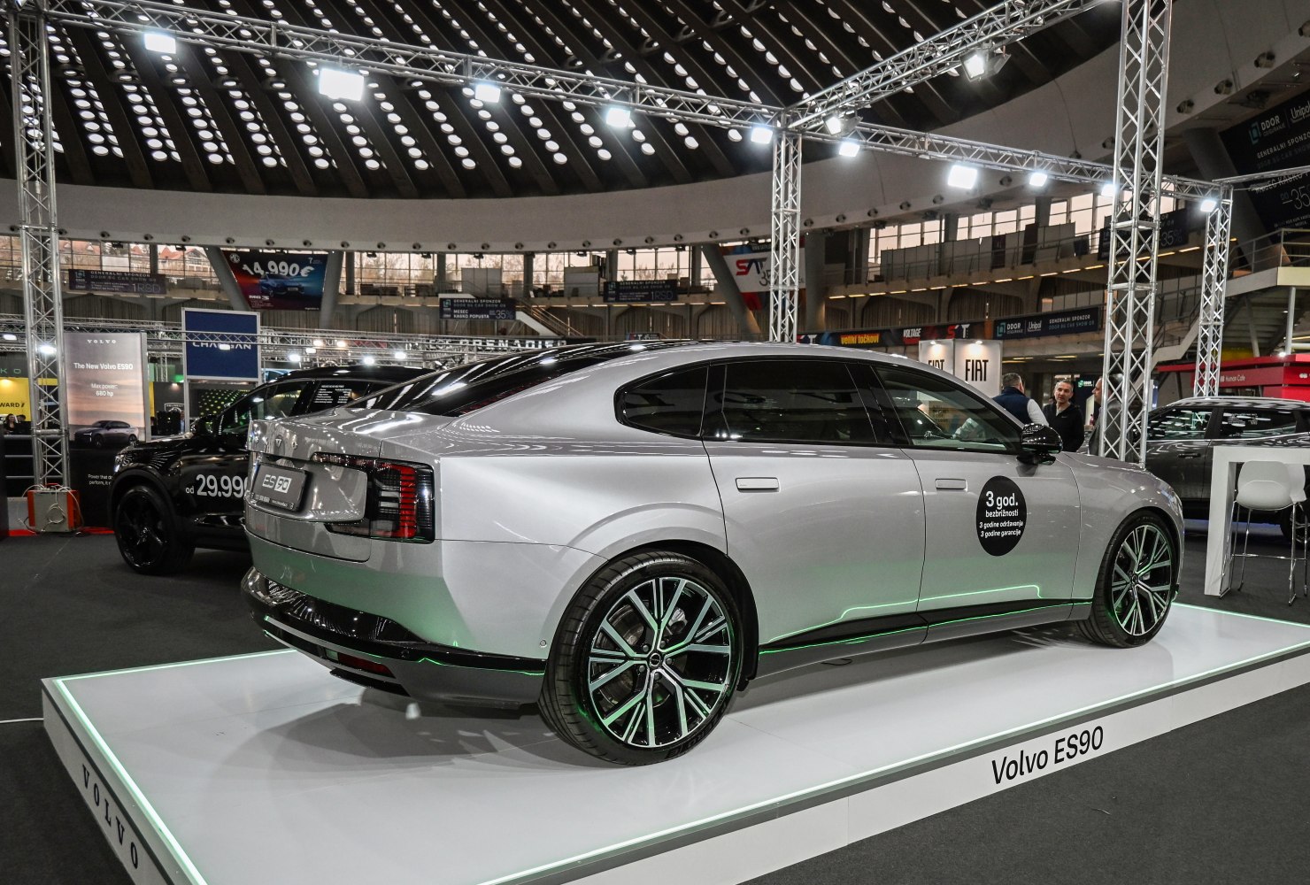 Silver electric sedan rear and side view with alloy wheels and sleek design