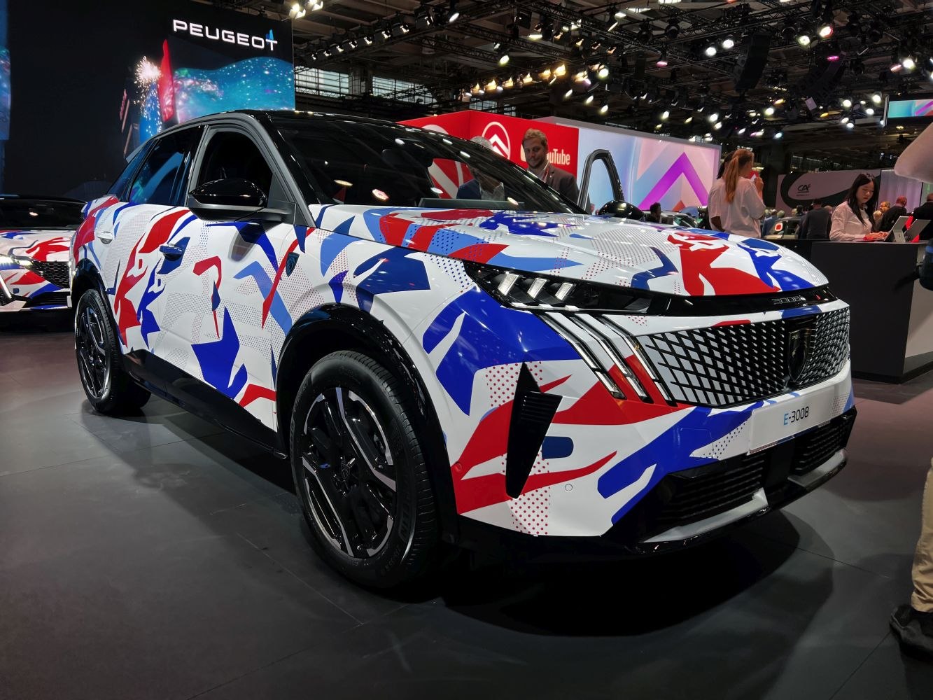 Bold geometric grille and colorful camouflage on front-side view