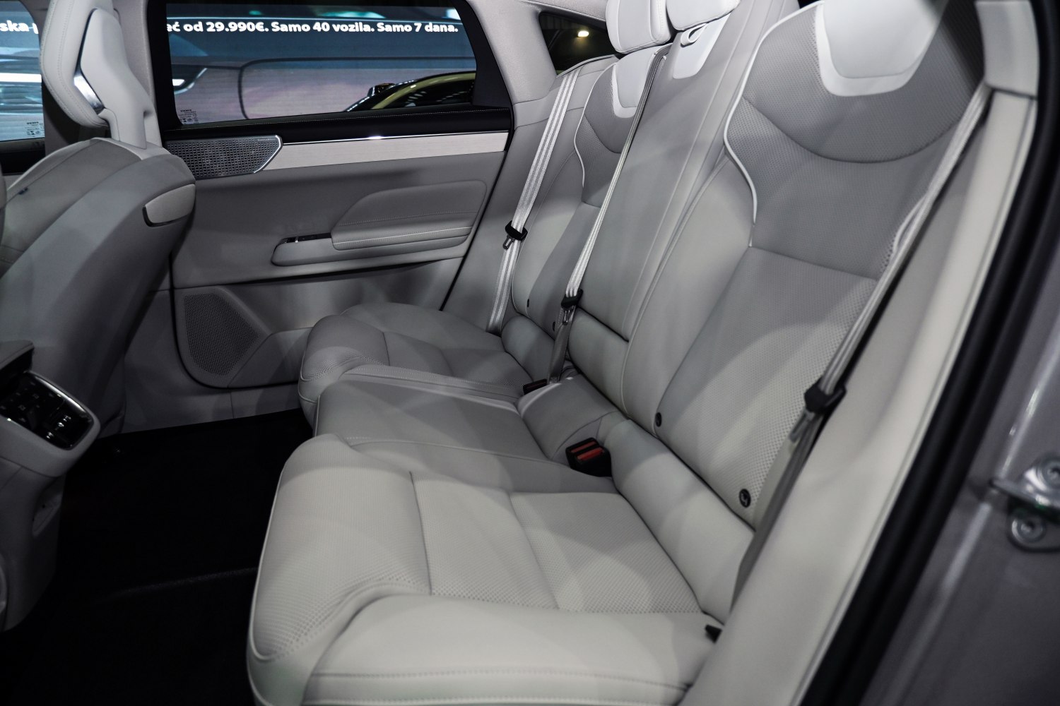 Spacious rear seats in light gray leather upholstery