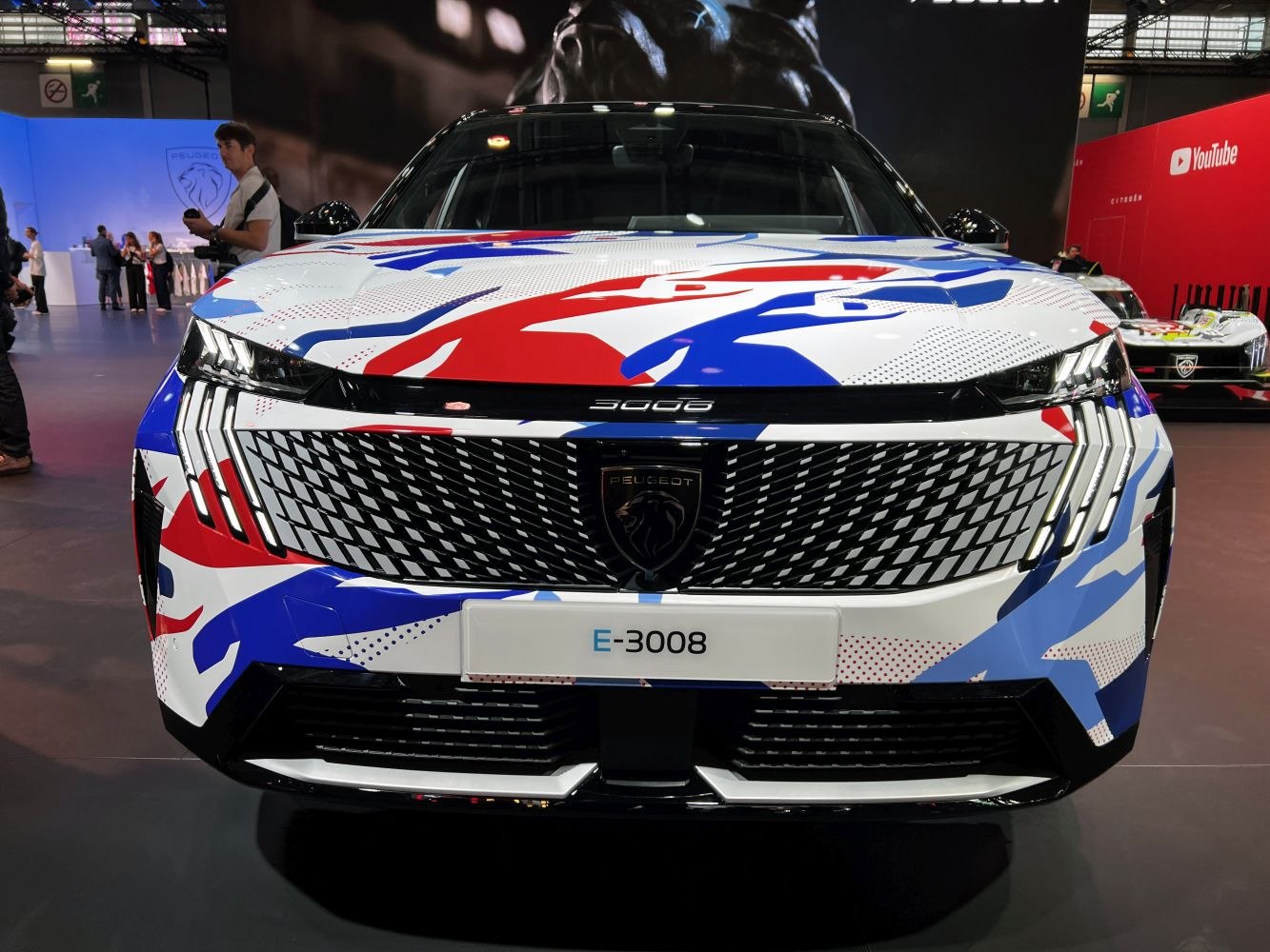 Front grille and headlight design with vibrant red, blue, and white graphic wrap