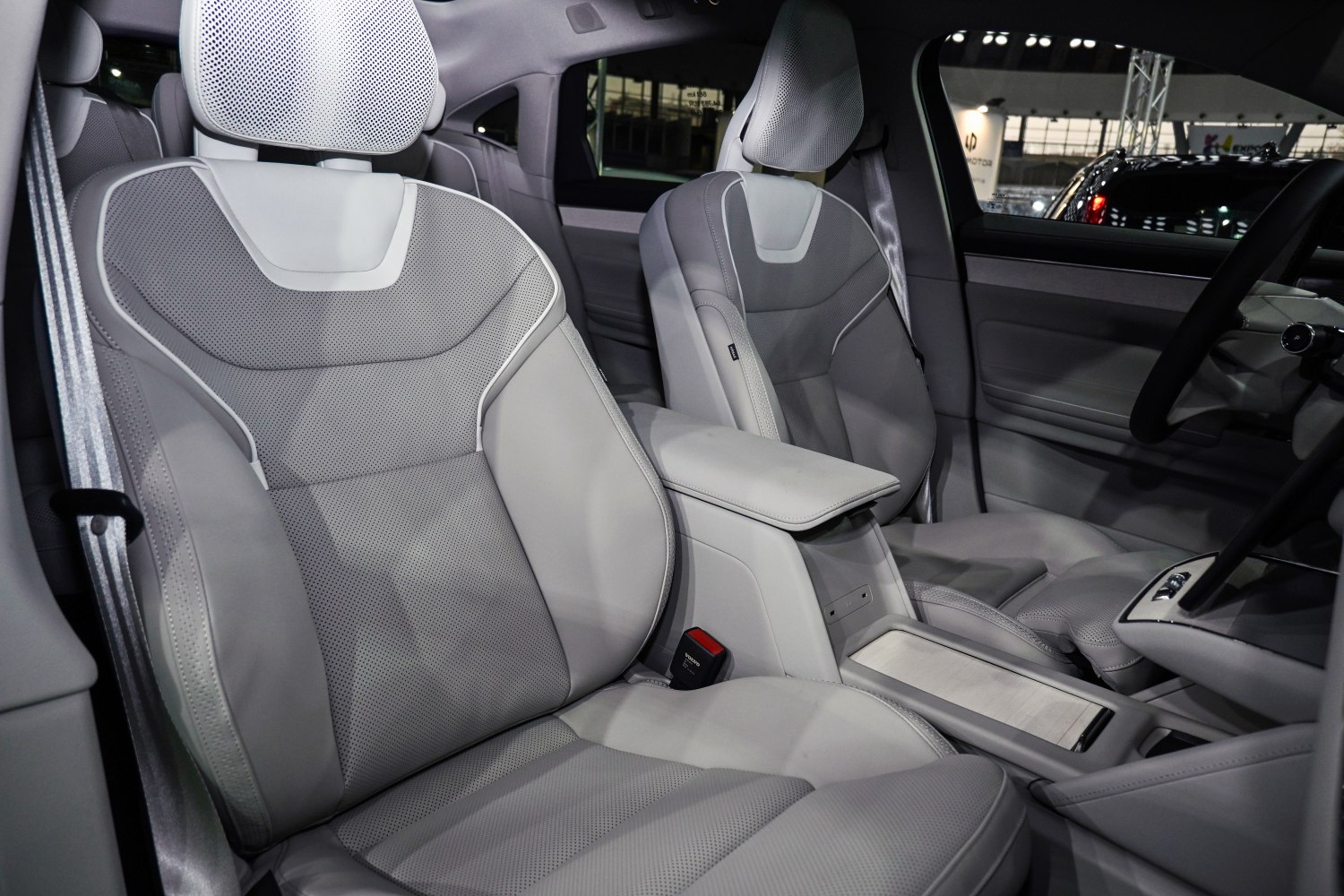 Luxurious perforated leather front seats and center console of a modern vehicle.