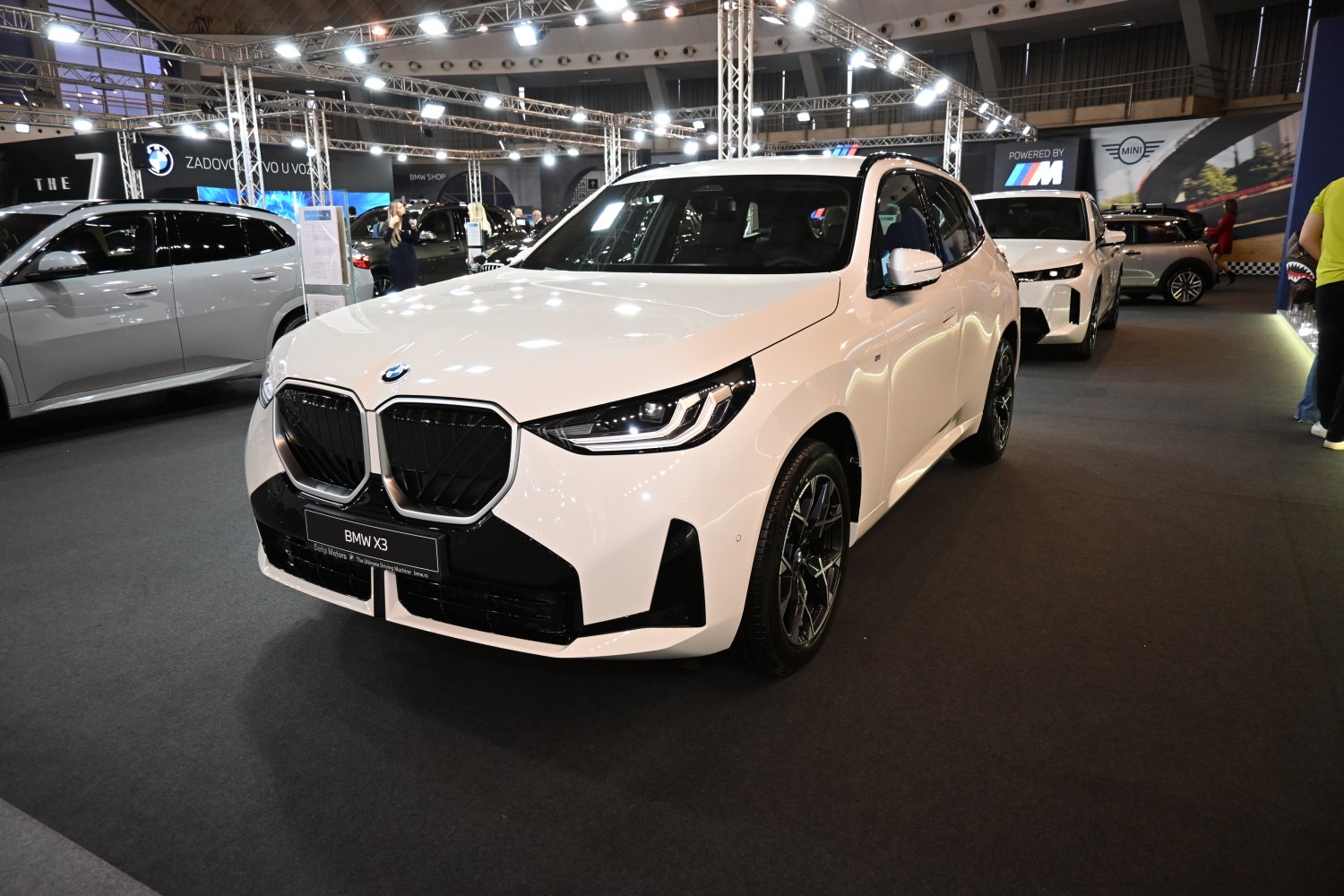 Front view of a 2025 SUV featuring a large kidney grille and sleek headlights