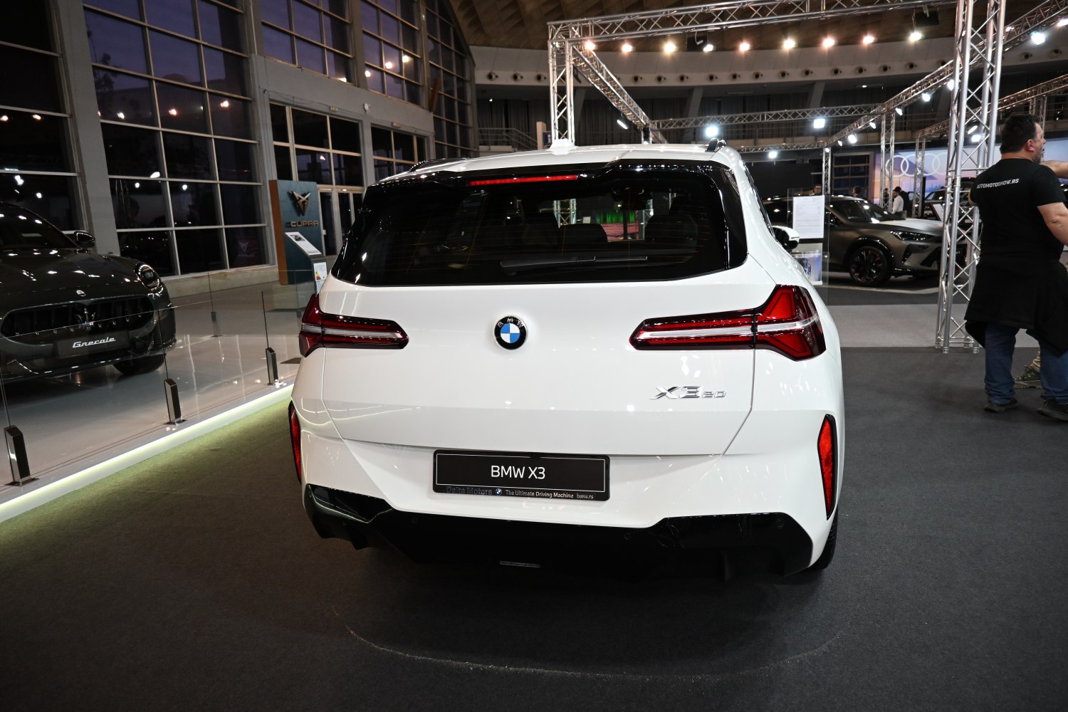 Rear view of a white SUV with sleek horizontal taillights and sporty rear design