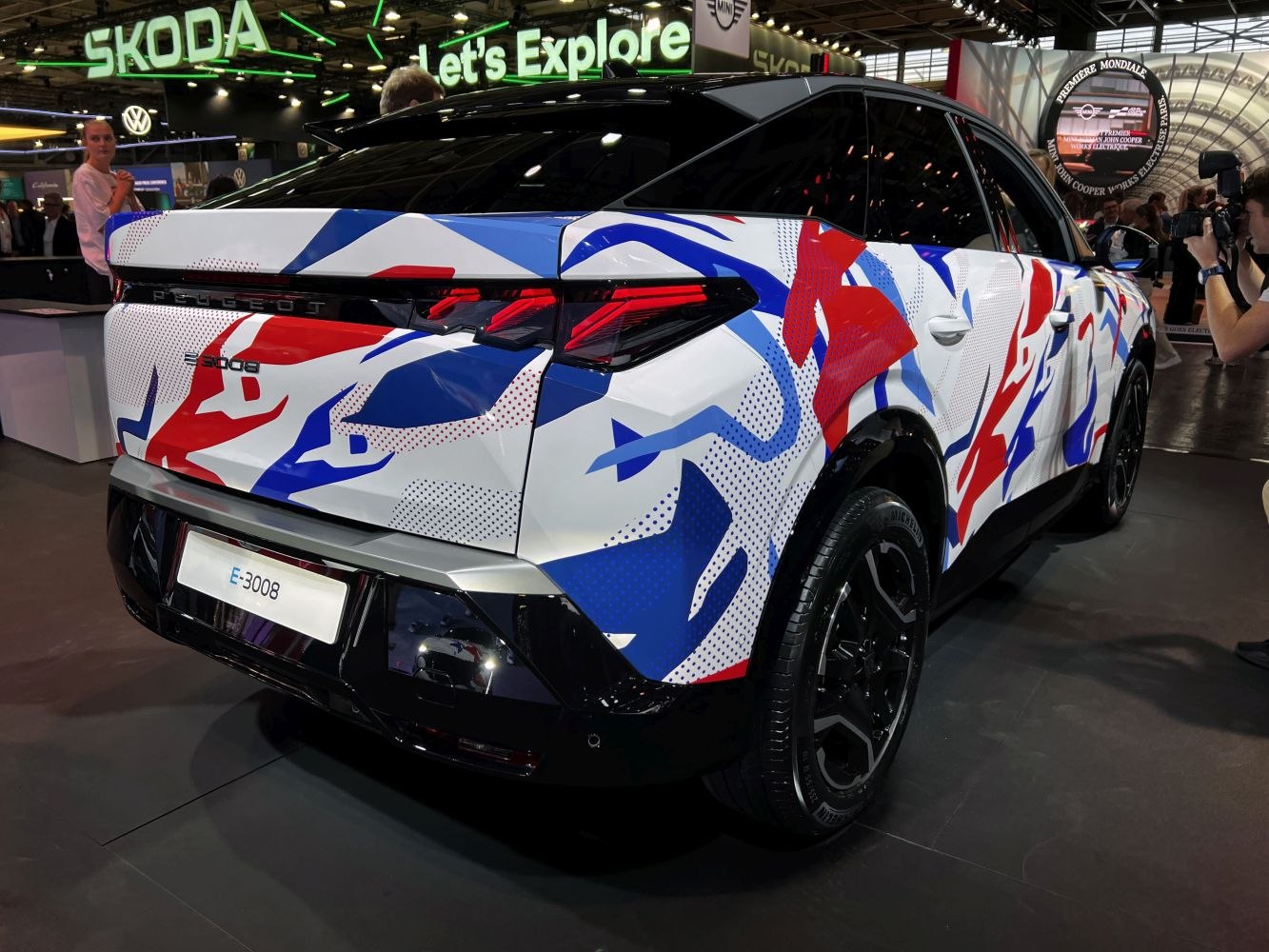 Rear and side view of SUV with angular taillights and bold camouflage wrap