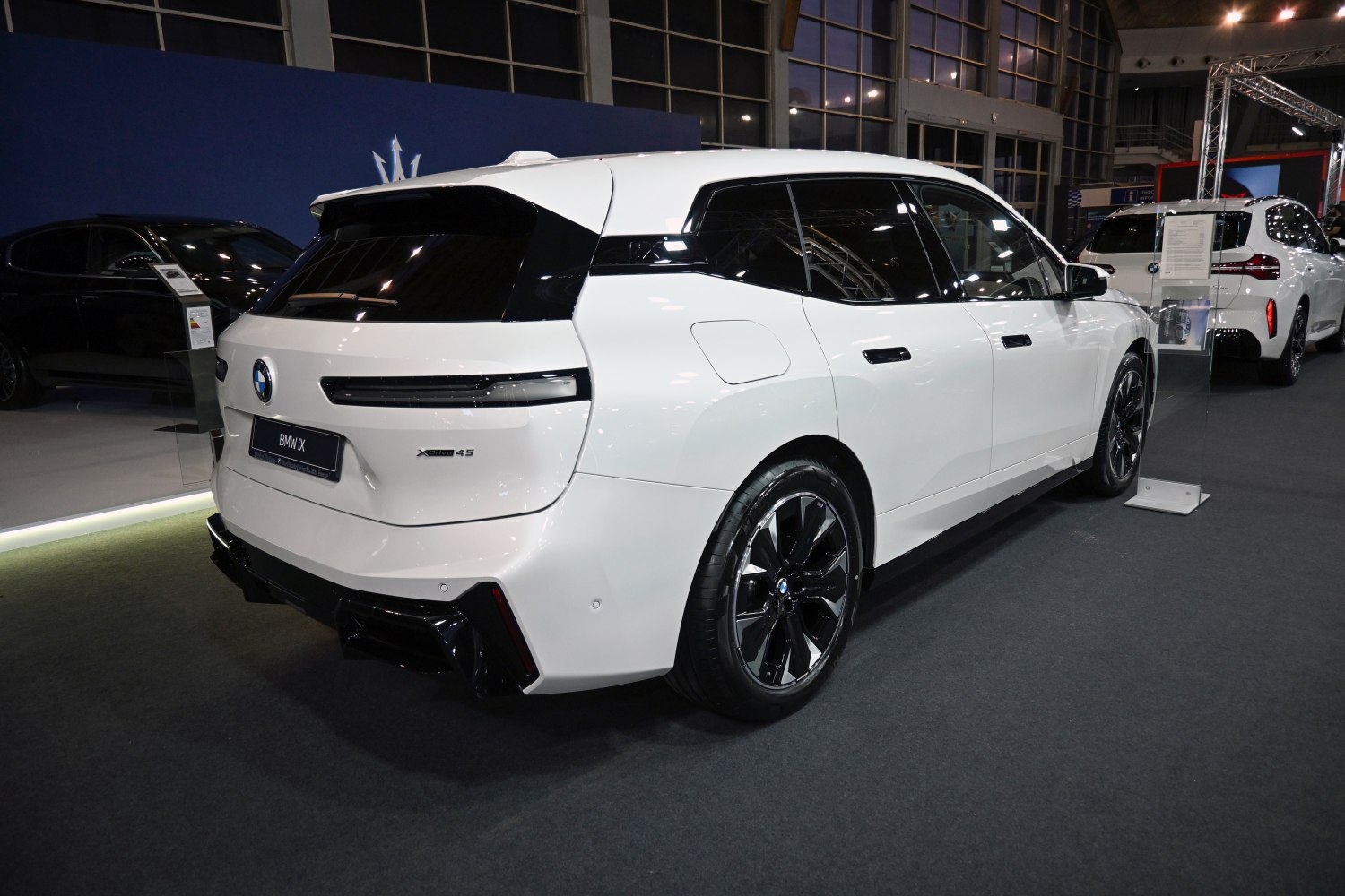 Rear side view of modern electric SUV with distinctive wheels