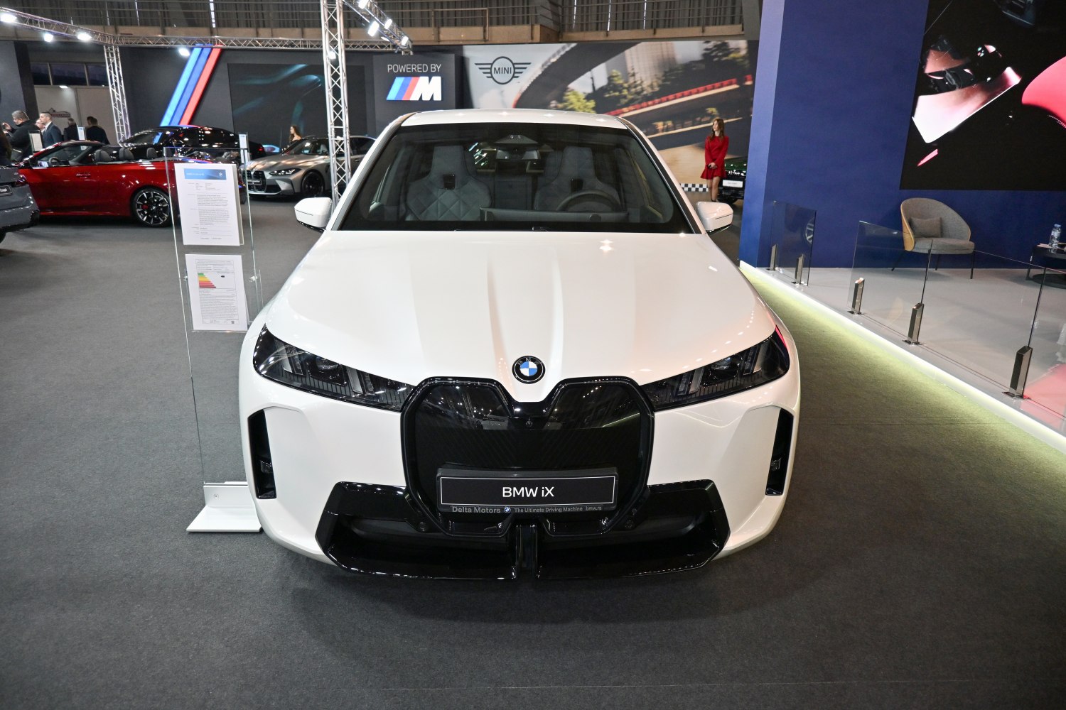 Large grille and sleek angular headlights on white SUV front.