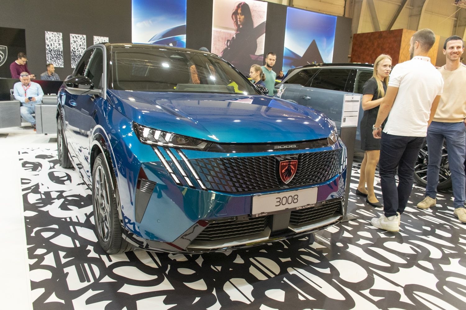 Modern front grille and sharp split headlights on a blue SUV