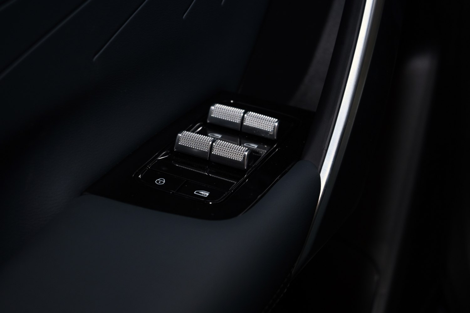 Metallic textured window switches and door lock buttons on car door panel