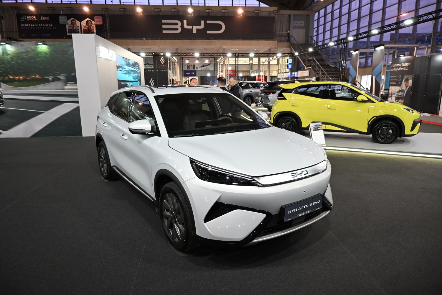 White electric SUV front with sleek headlights and distinct grille.