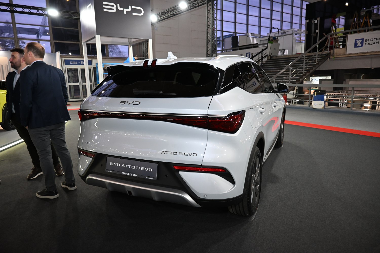 Rear view of white electric SUV with sleek LED taillights and modern bumper.