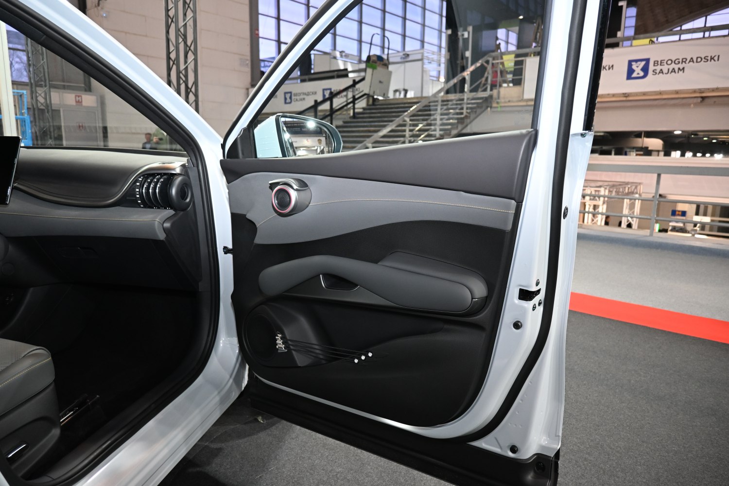 Modern car door panel with speaker and armrest