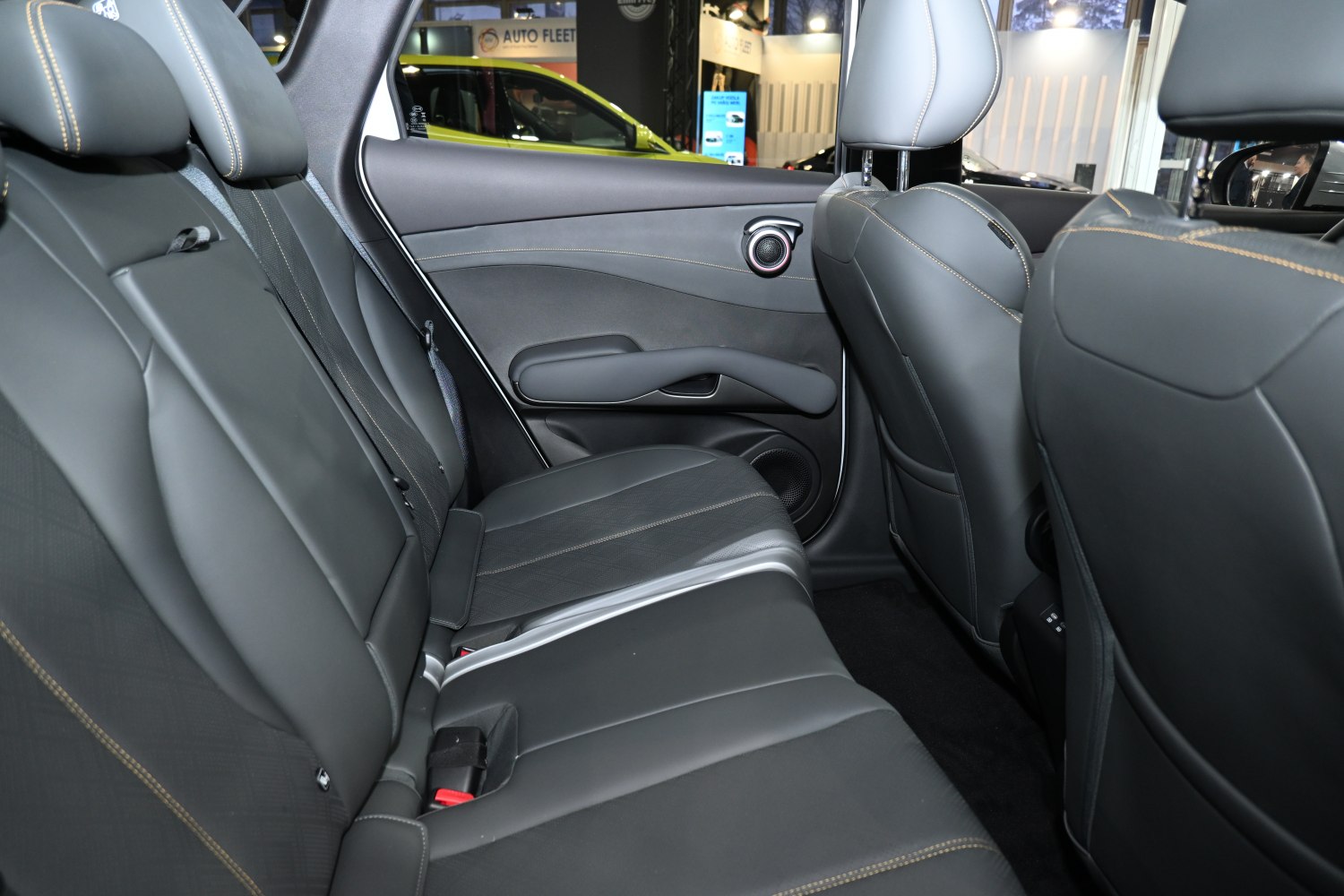 Modern rear seats with leather upholstery and integrated door speaker