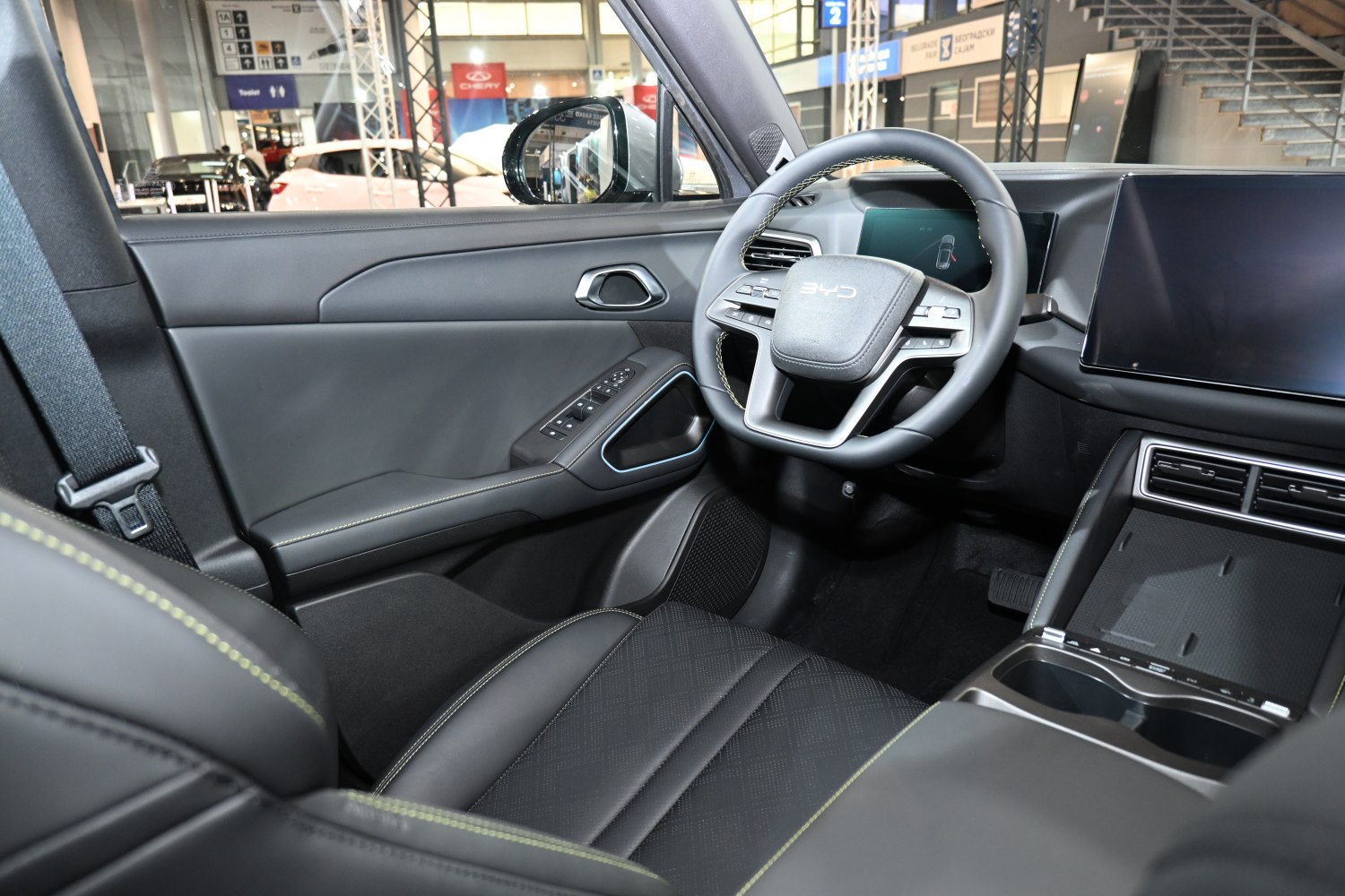 Futuristic steering wheel and digital dashboard interior with black upholstery
