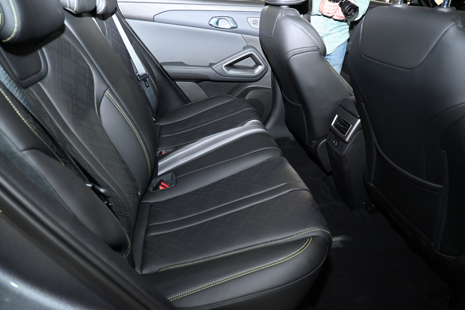 Rear seat with black leather upholstery and premium stitching