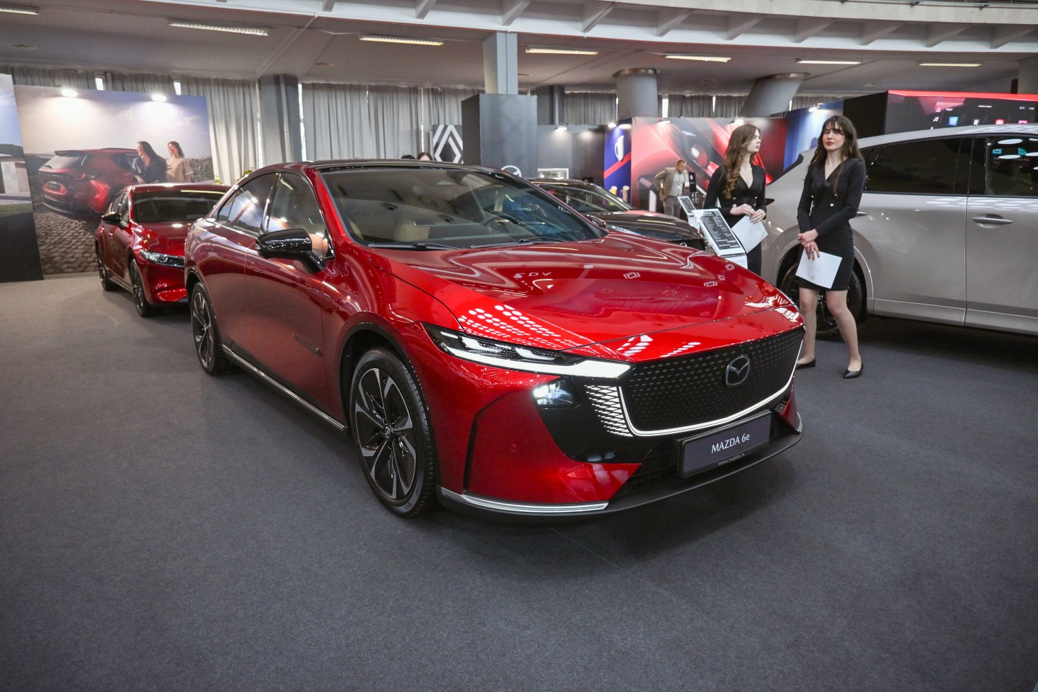 Red sedan with bold grille and sharp LED headlights