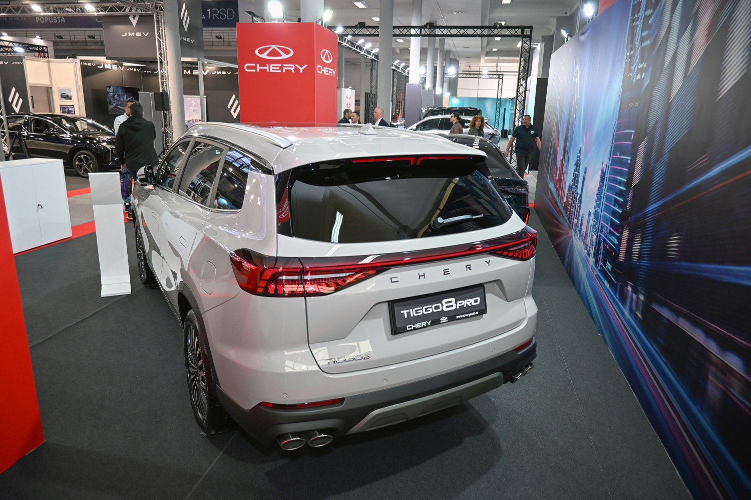 SUV rear with LED light bar, quad exhaust tips, and rear spoiler