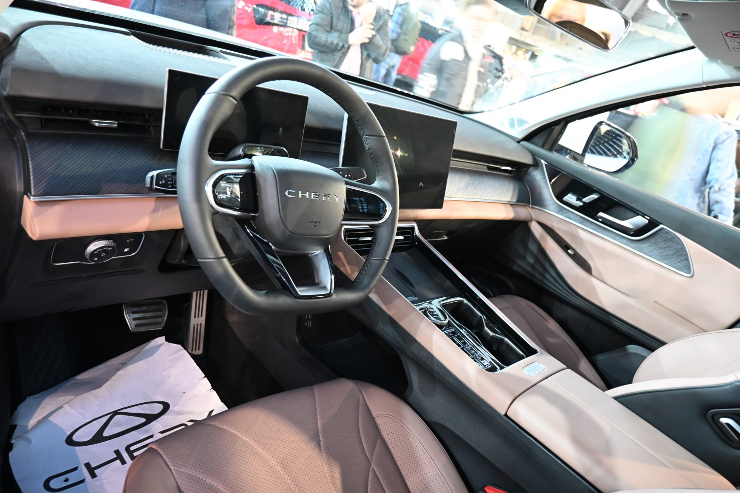 Dual digital displays and modern steering wheel in a premium car interior