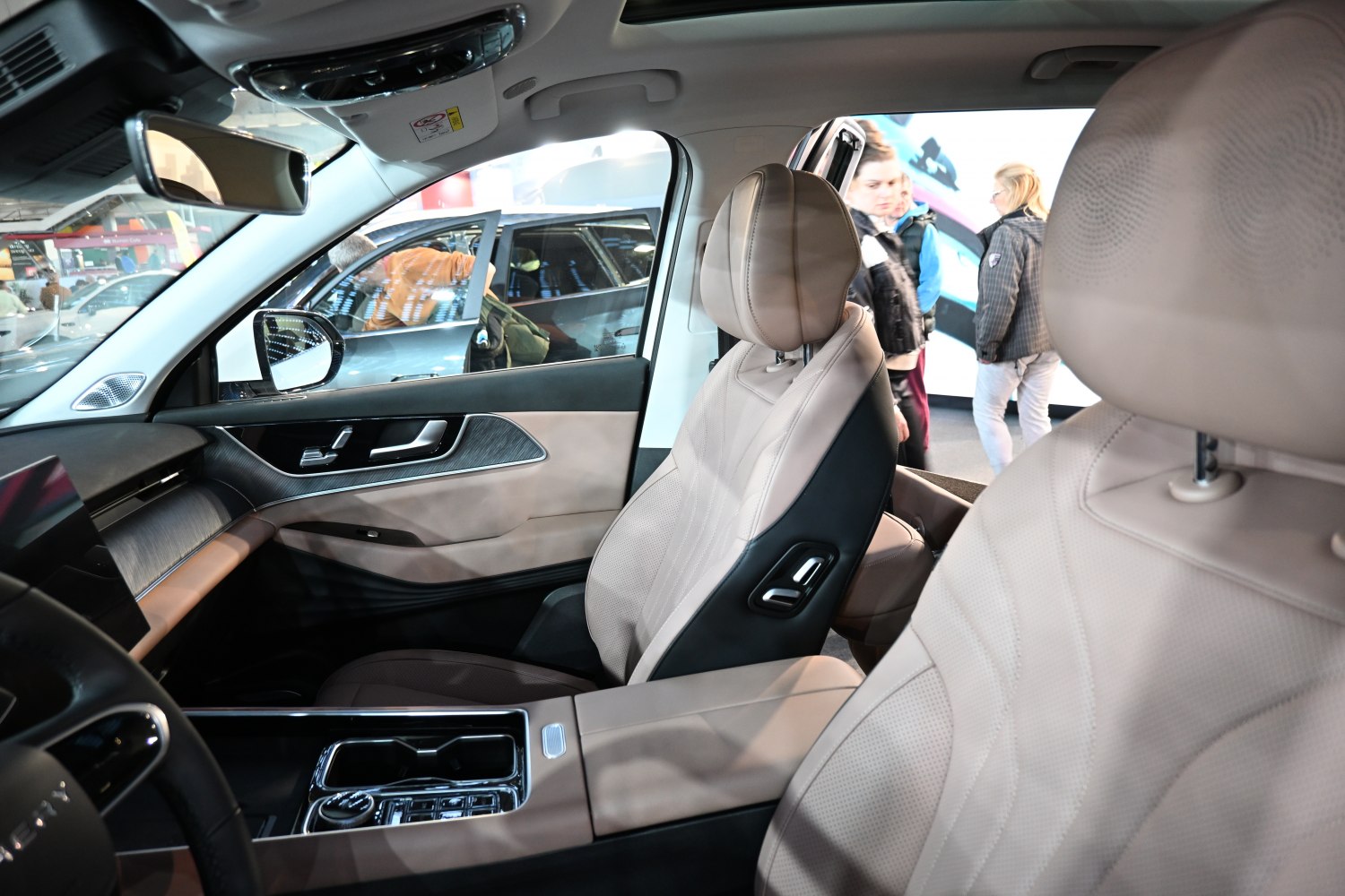 Premium beige leather seats with advanced center console and door panel.