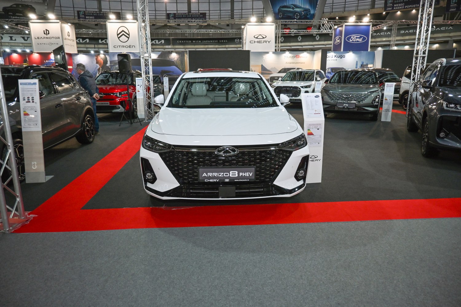 White vehicle front with large black grille and LED headlights