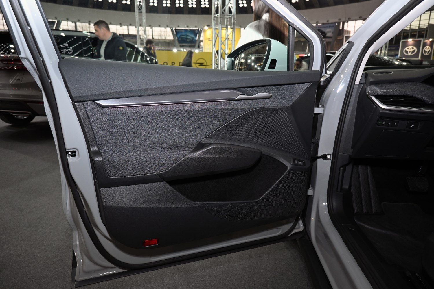 Modern car door panel with fabric and polished handle