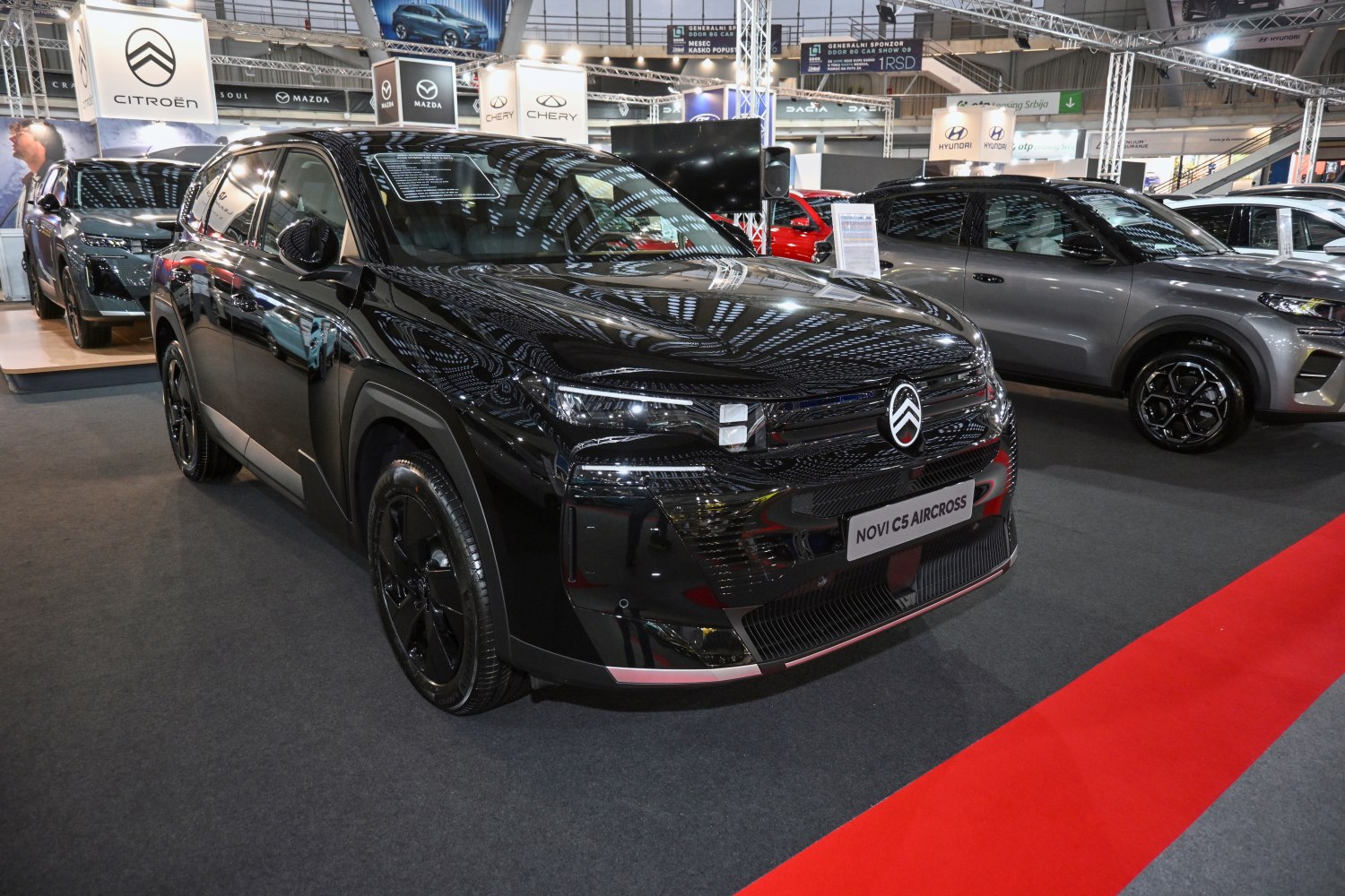 Futuristic black electric SUV with angular LED headlights and smooth body design.