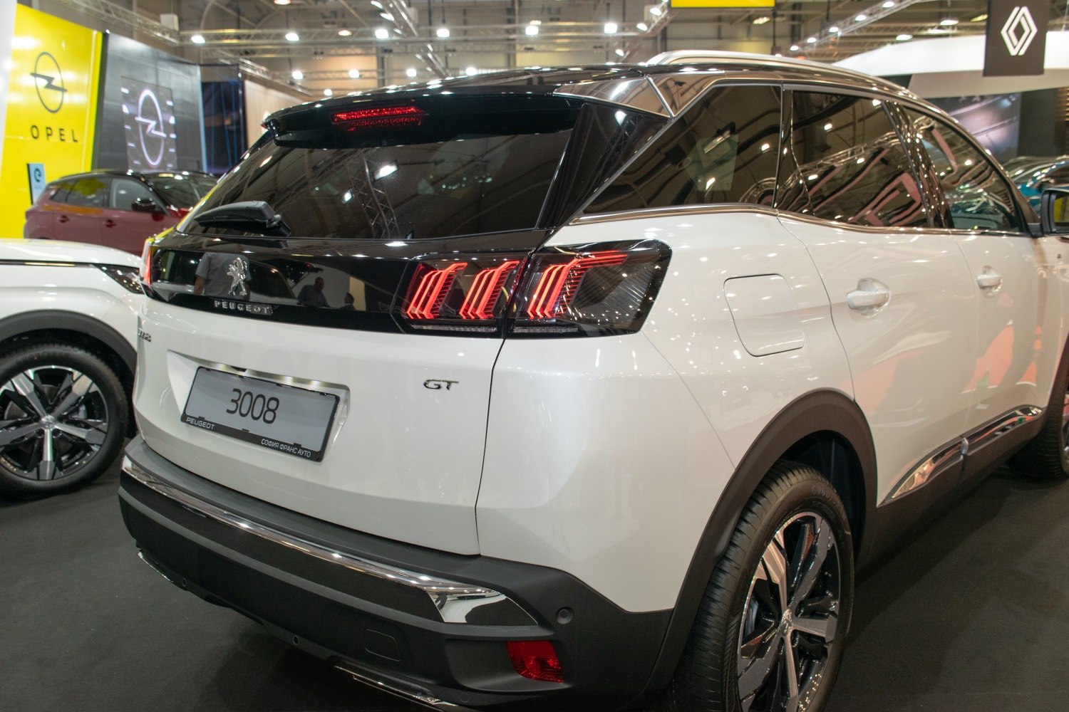Rear view with distinctive LED tail lights and black roof