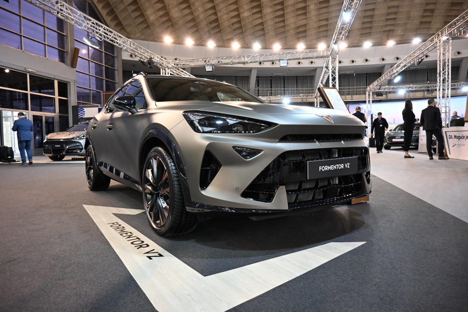 Sporty front view with aggressive headlights and large grille
