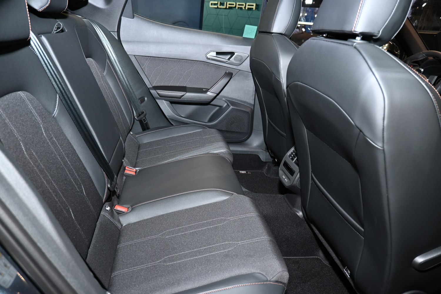 Rear seat interior with mixed upholstery and detailed stitching