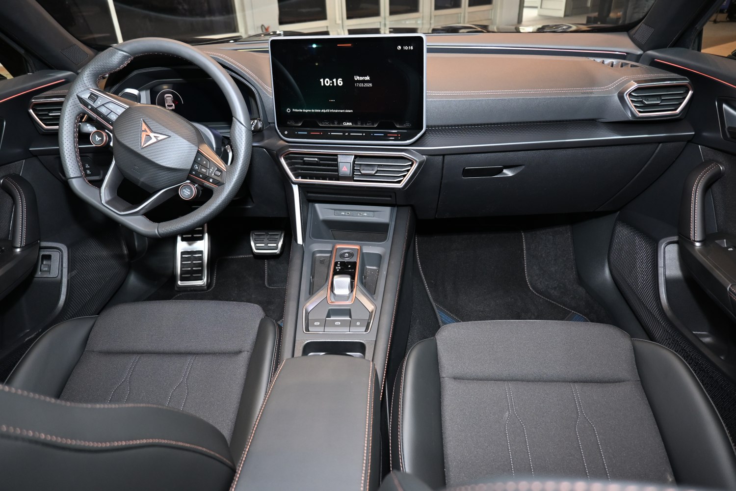Modern digital dashboard and multifunction steering wheel with central touchscreen.
