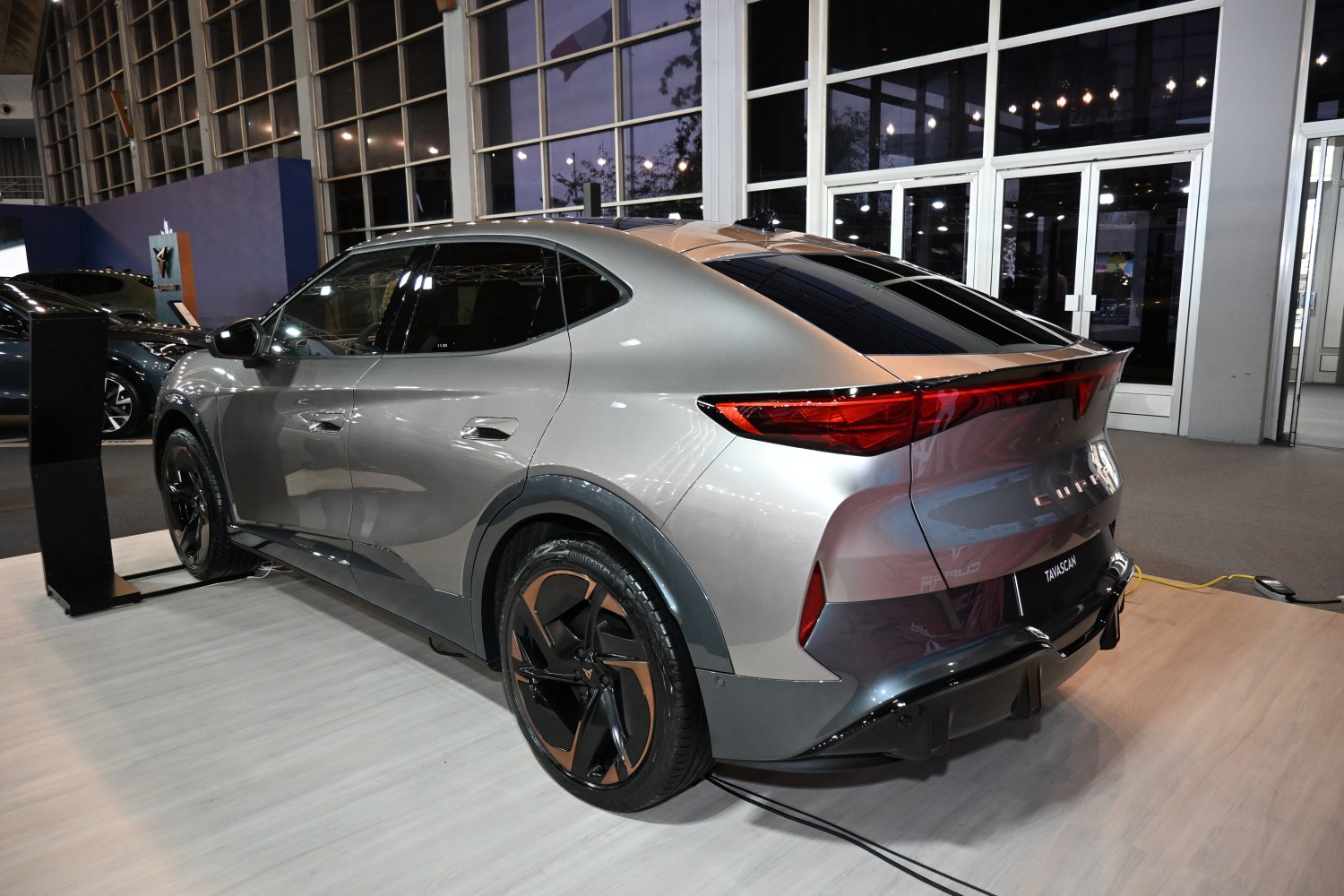 Rear view of a modern SUV coupe with sharp taillights and two-tone alloy wheels.