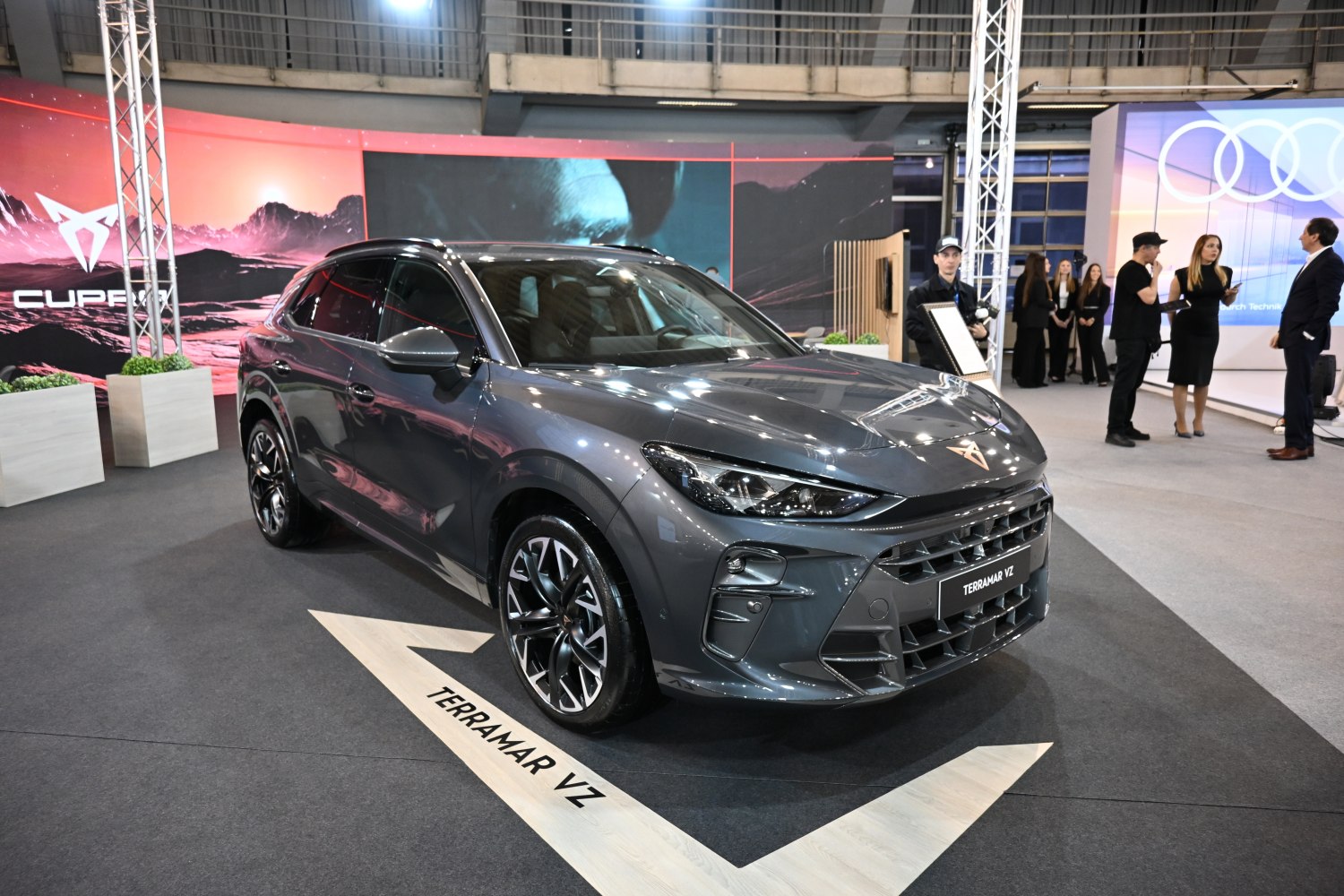 Front side view of a sporty SUV with sleek headlights and bold grille