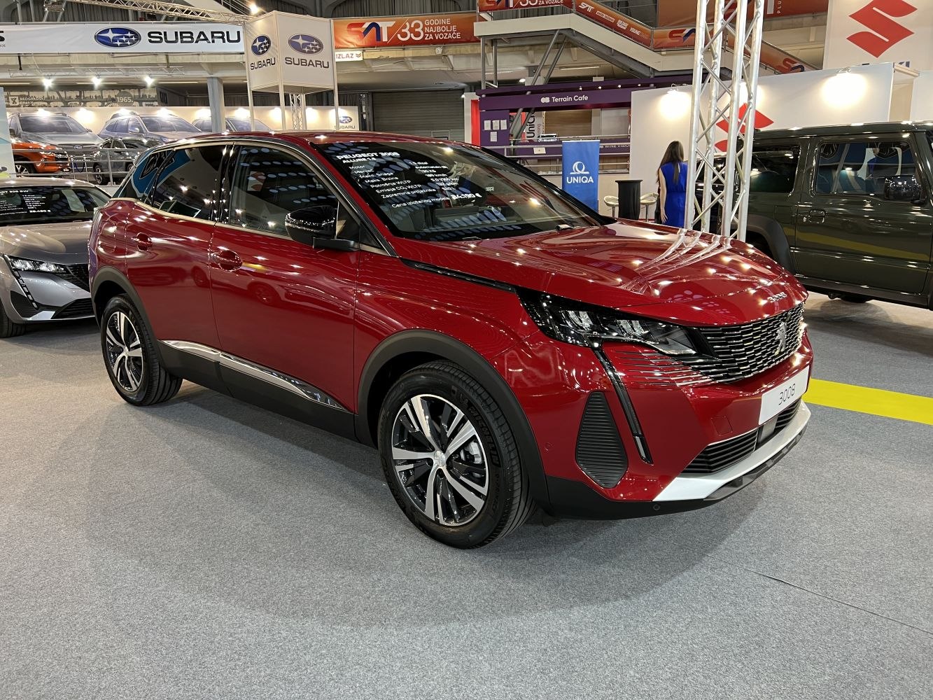 Red SUV with sleek headlights and alloy wheels in front-side view