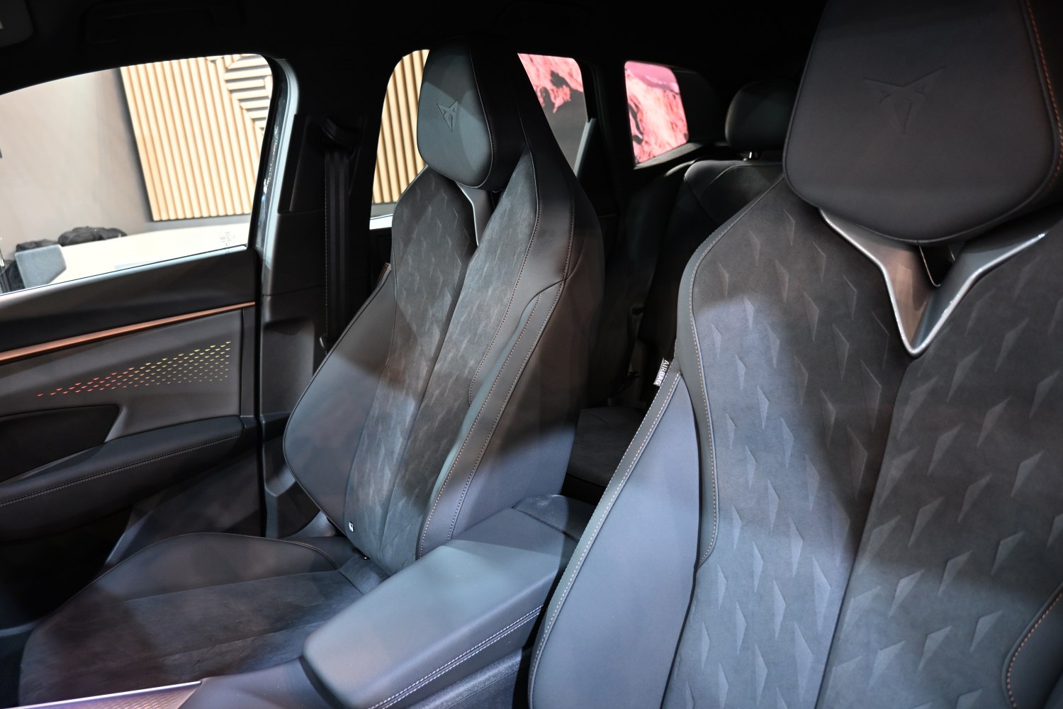 Luxury sport seats with embossed logos and detailed stitching