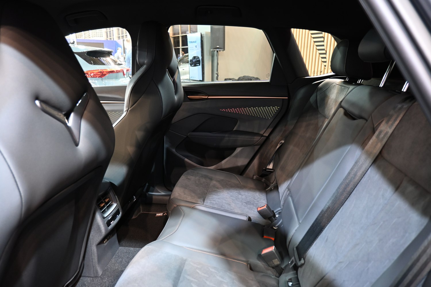 Modern rear seat interior with spacious design and ambient lighting