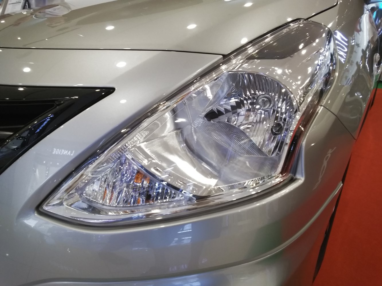 Close-up of Nissan Almera III 2015 facelift front headlight