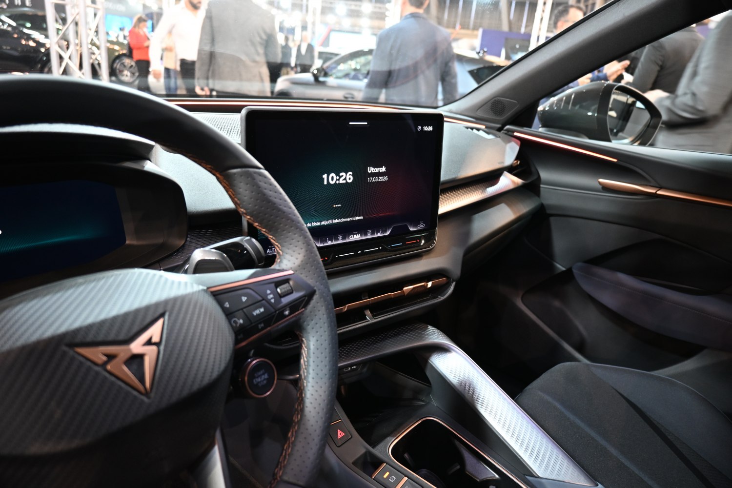 Digital dashboard and central touchscreen with steering wheel controls inside a modern car interior