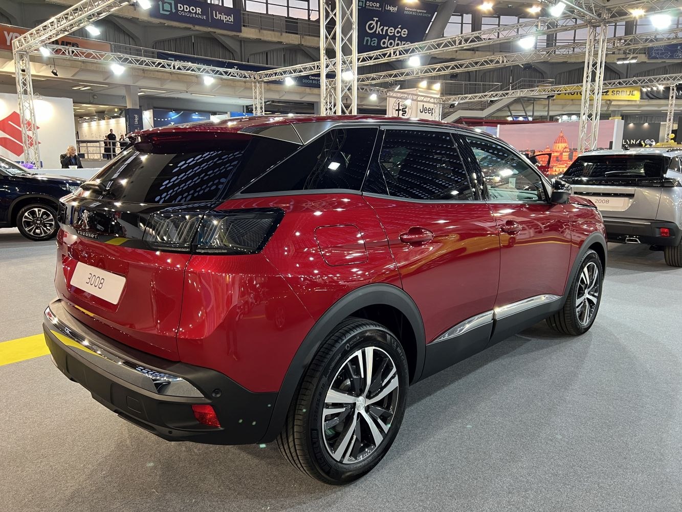 Red SUV rear side with distinctive lights and alloy wheels