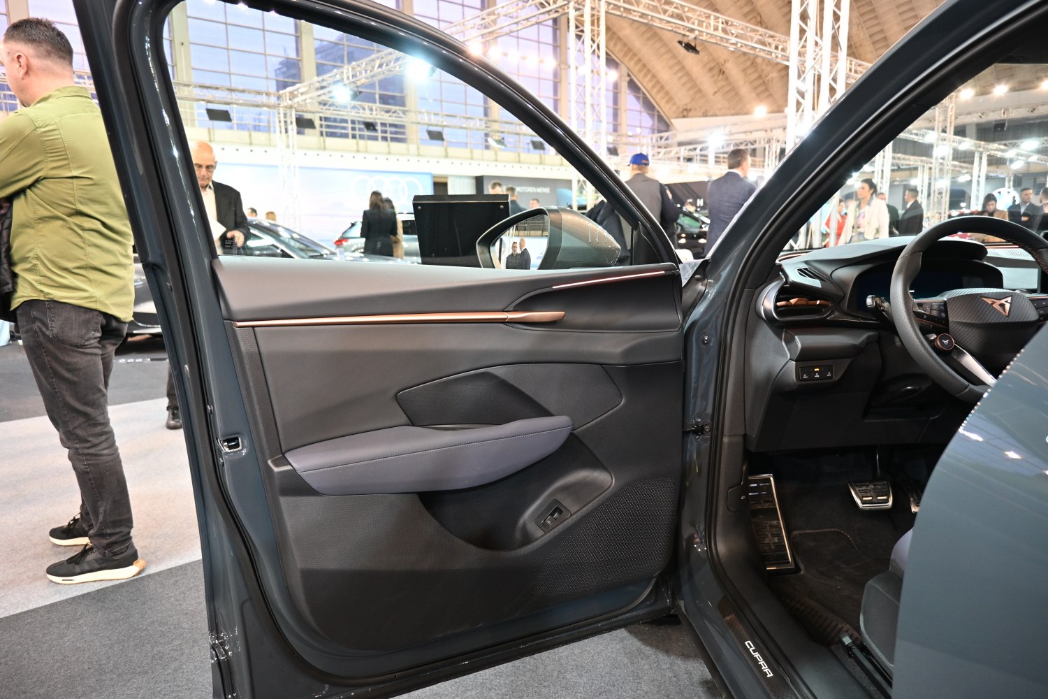 Modern car interior with door panel, steering wheel, and dashboard details