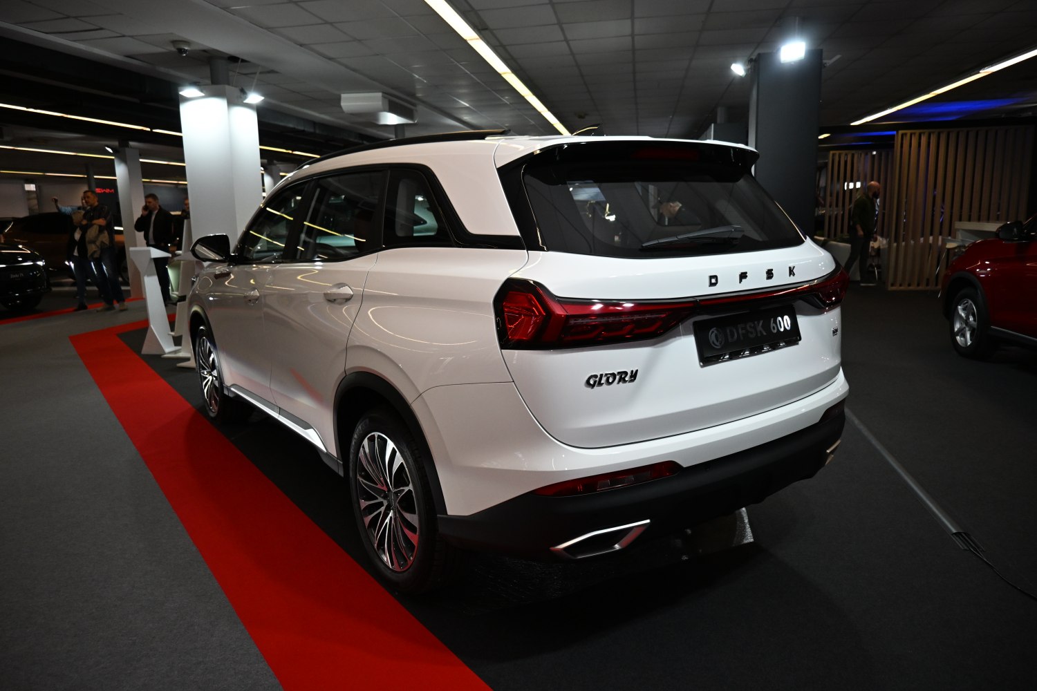 SUV rear view with LED taillights, alloy wheels, and rear spoiler