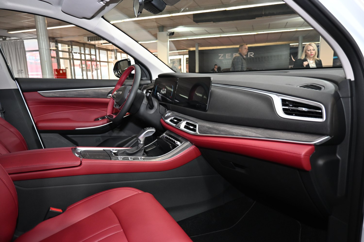 Red leather seats and digital dashboard with wood trim