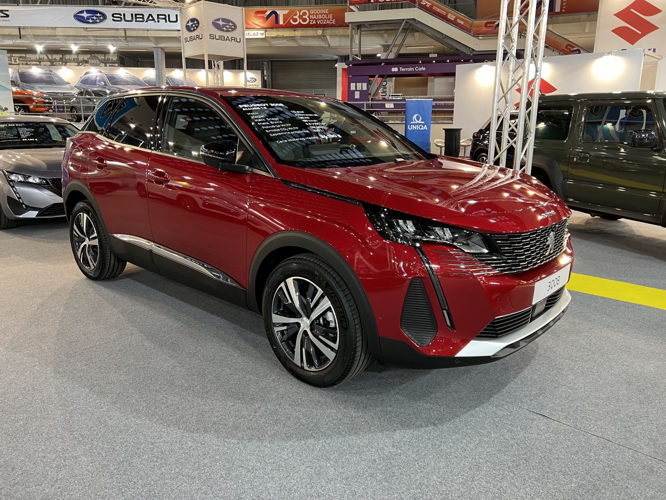 Red compact SUV with LED headlights and modern grille