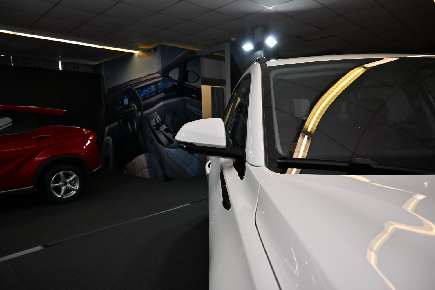 Close-up of white side mirror and front body panel with sleek contours