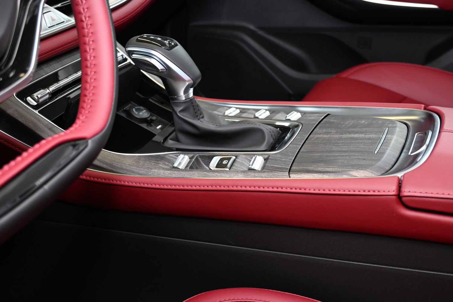 Automatic gear shift and wood-trimmed center console with red leather wrap