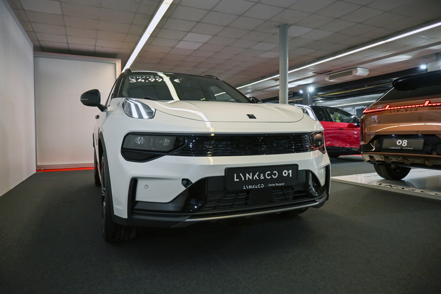 Front view with sleek headlights and wide grille
