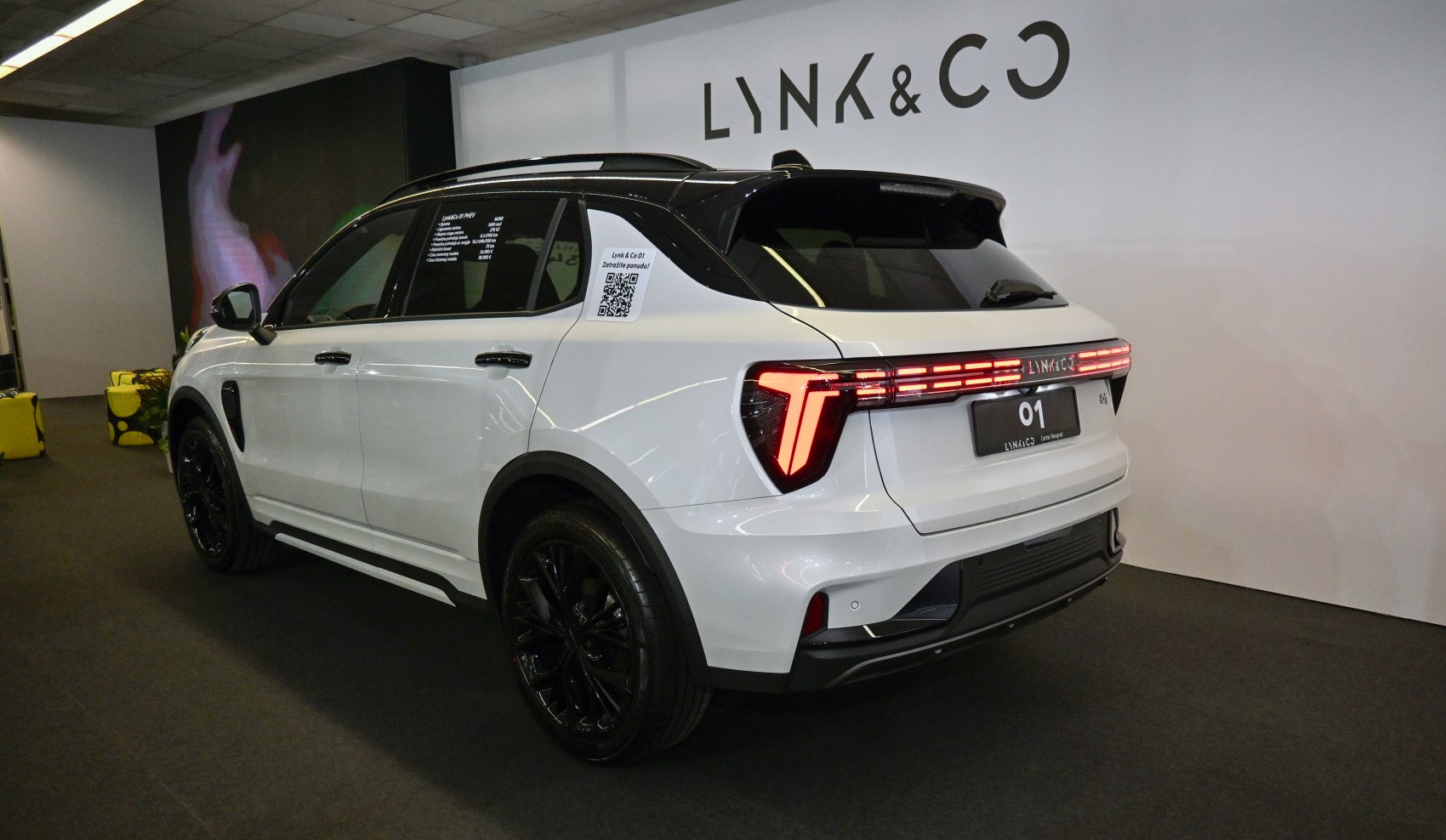 T-shaped LED taillights and black alloy wheels on white SUV rear