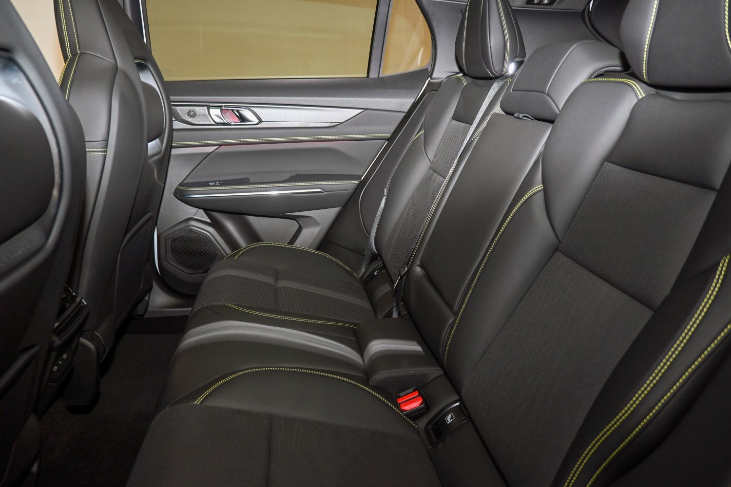 Rear seat interior with black upholstery and yellow stitching
